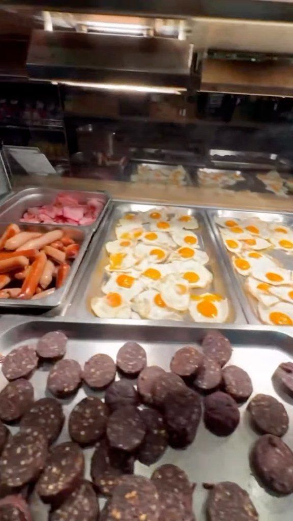 Trays of rashers, sausages, fried eggs and black and white pudding ready for breakfast rolls